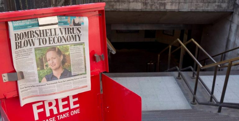 A newspaper stand with a person skateboarding on it.